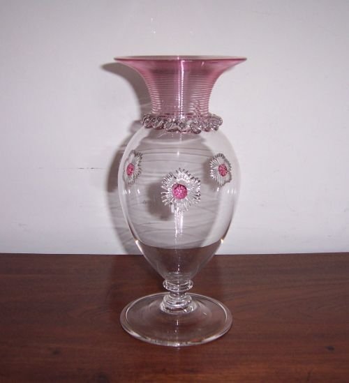 a victorian glass vase with cranberry trailing