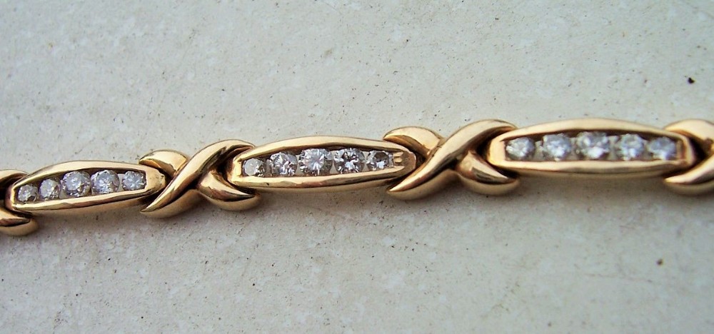a nice ladies 9 carat solid gold and diamond bracelet