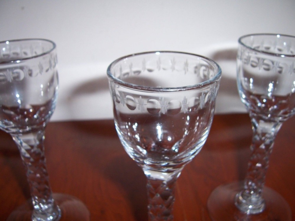 a good set of three 18th century facet cut stem cordial wine glasses