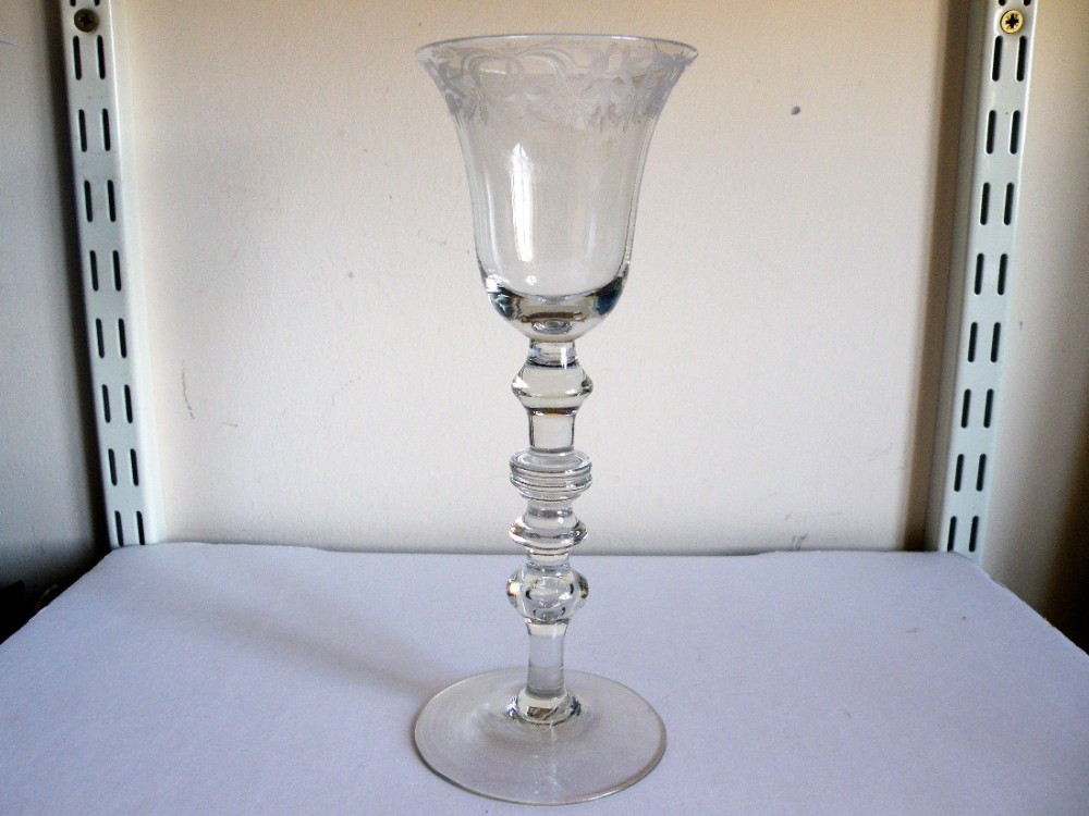 an extremely rare early18th century engraved newcastle light baluster wine glass