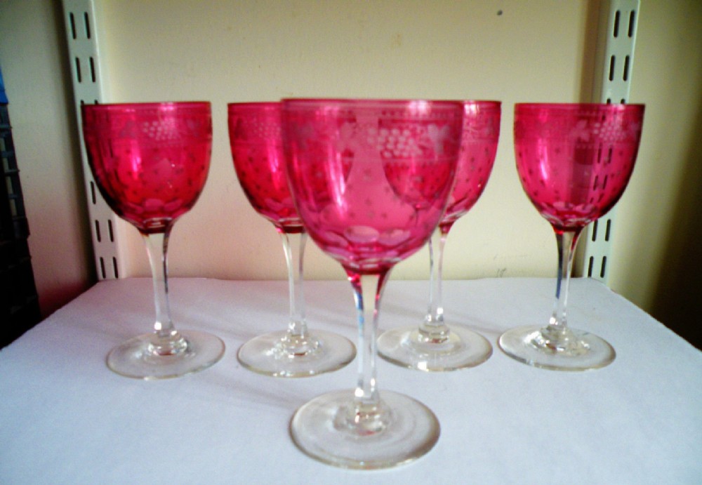 a good set of five victorian engraved cranberry glass wine glasses