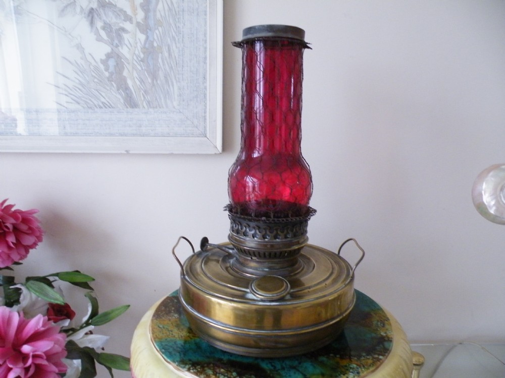 a large victorian ruby glass and brass oil lamp heater sepulchre belgique burner