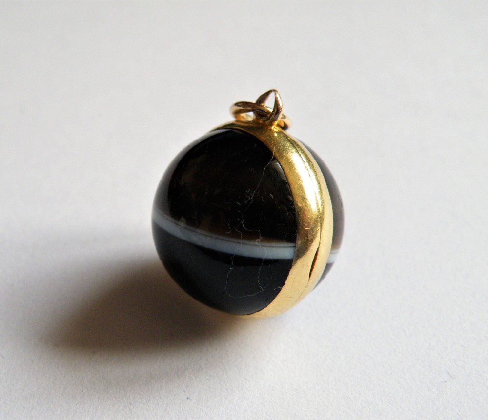 a rare mid 19th century banded agate locket with hair compartment