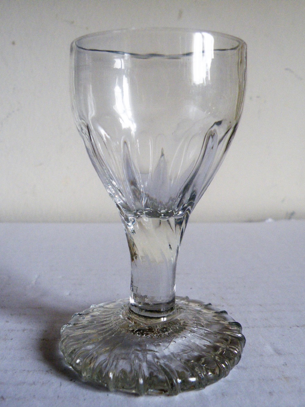 an 18th century toast masters firing glass with a thick ribbed moulded foot