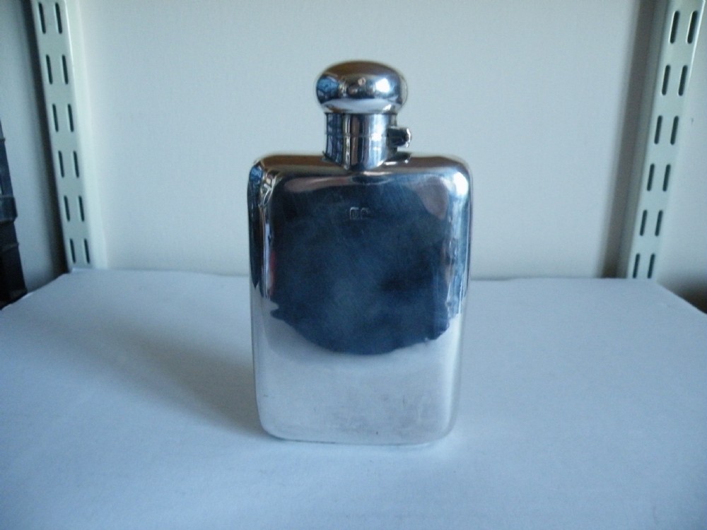 a solid silver curved hip flask
