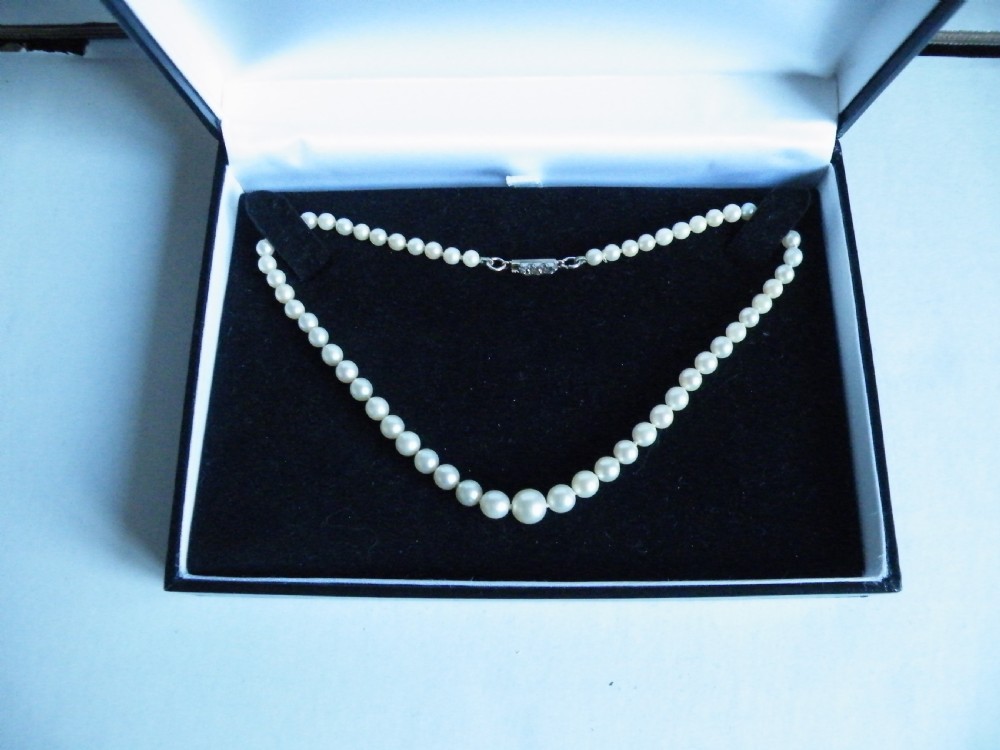 a young girls 19th century graduated pearl chocker necklace with diamond set clasp