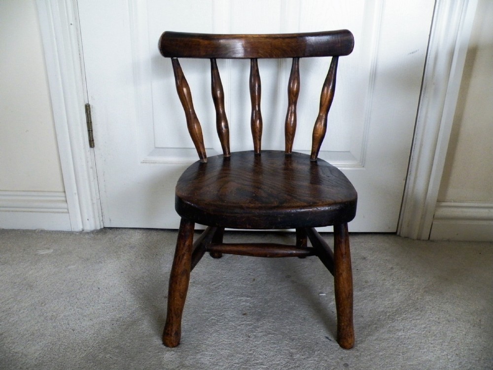 a 19th century childs country made elm chair