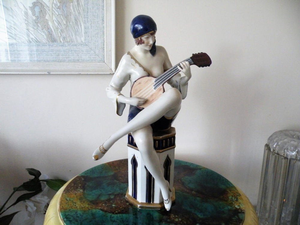 a large royal dux art deco figure of a lady playing a mandolin
