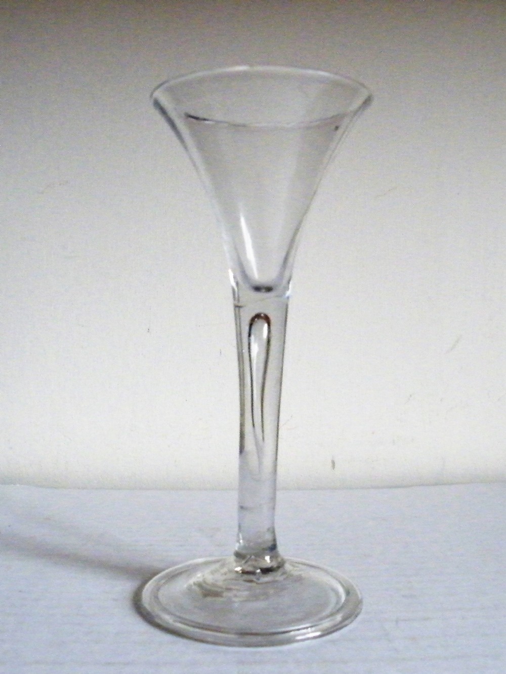 an 18th century wine glass drawn stem with tear circa 1740