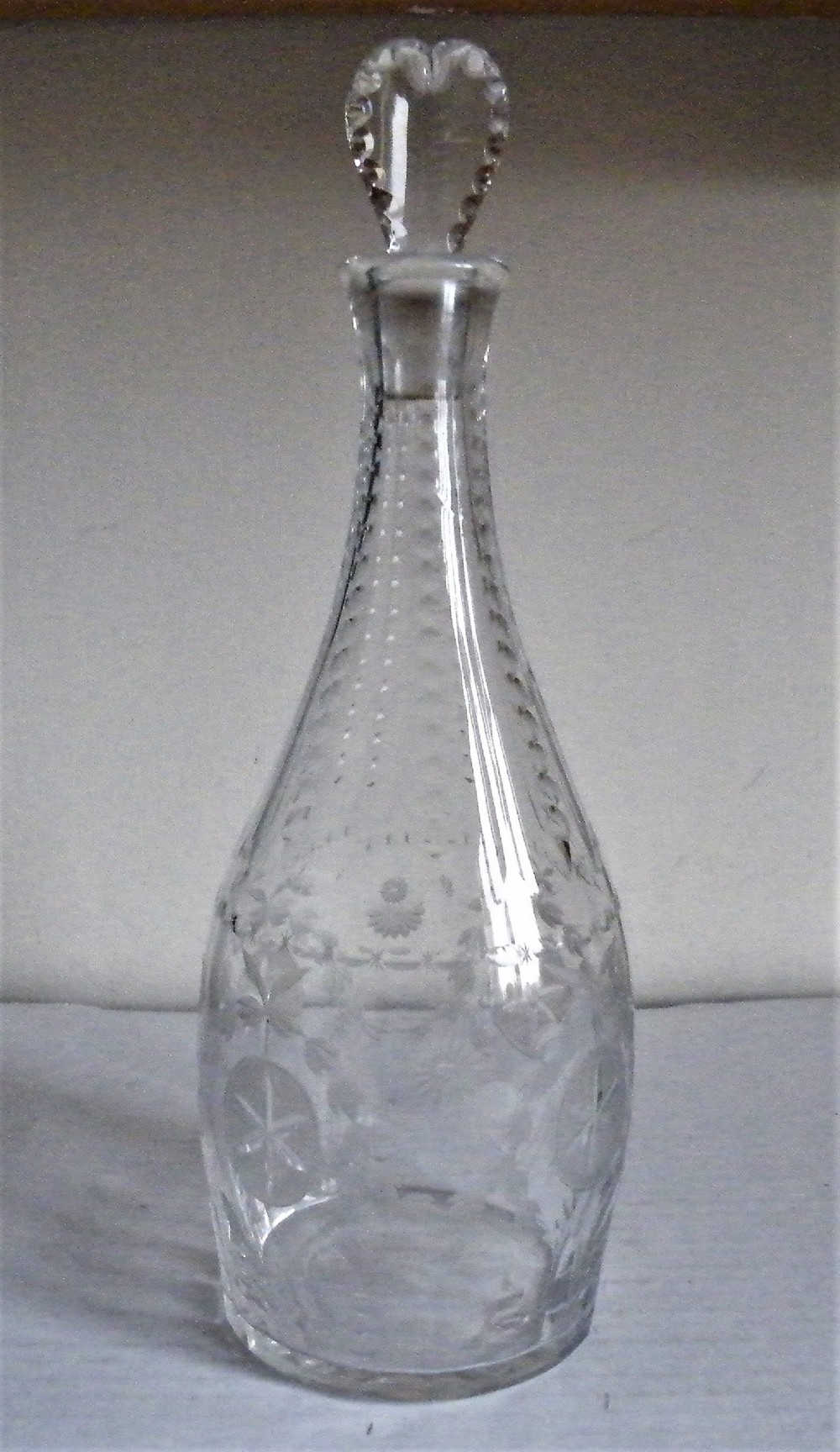 a superb engraved 18th century cut glass decanter with a heart stopper