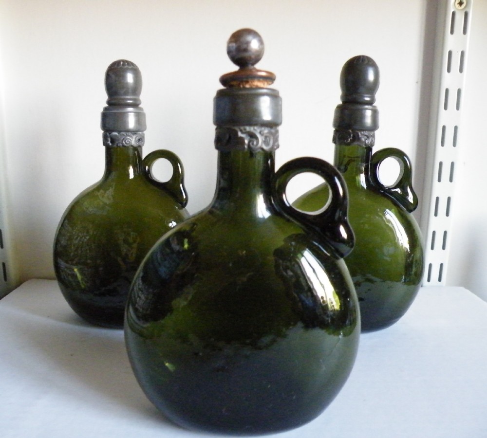 three 19th century olive green glass gin flasks