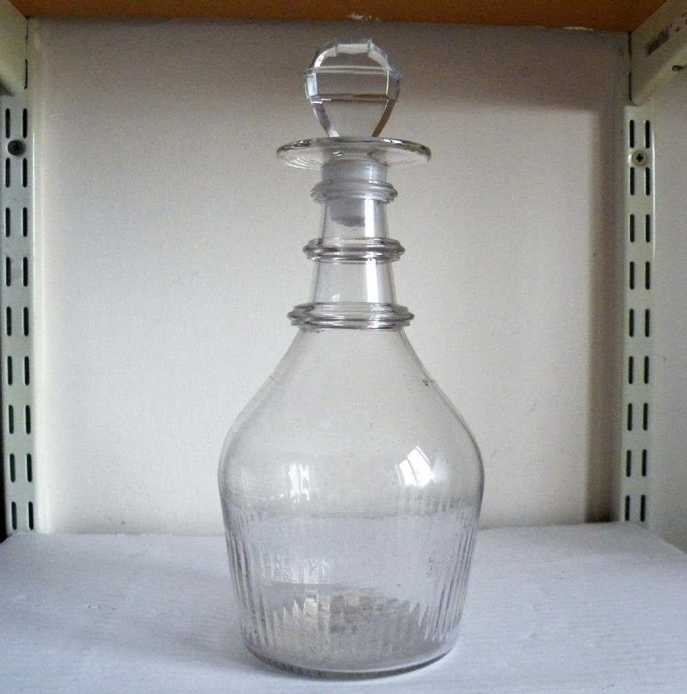 an 18th century irish glass three ring neck decanter with religious cross shape stopper