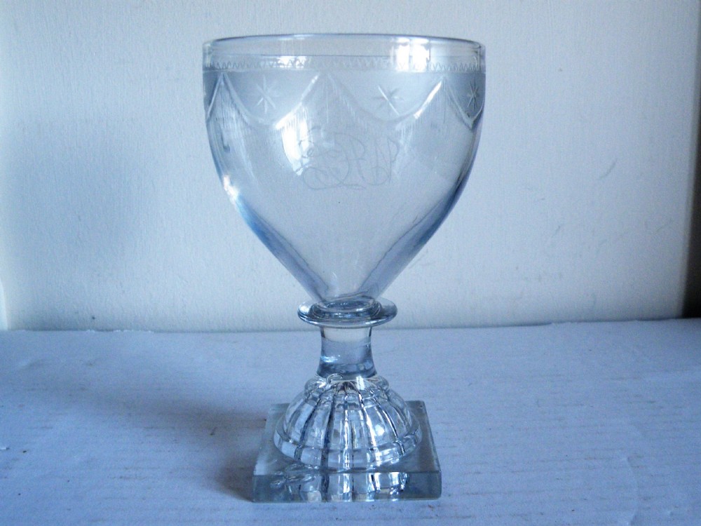 an 18th century engraved glass rummer with lemon squeezer base