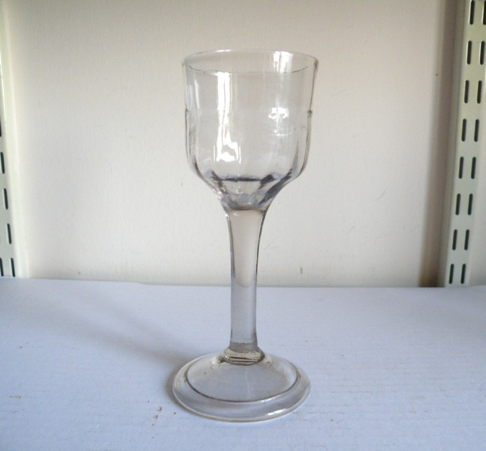 an 18th century plain stem wine glass with a folded foot