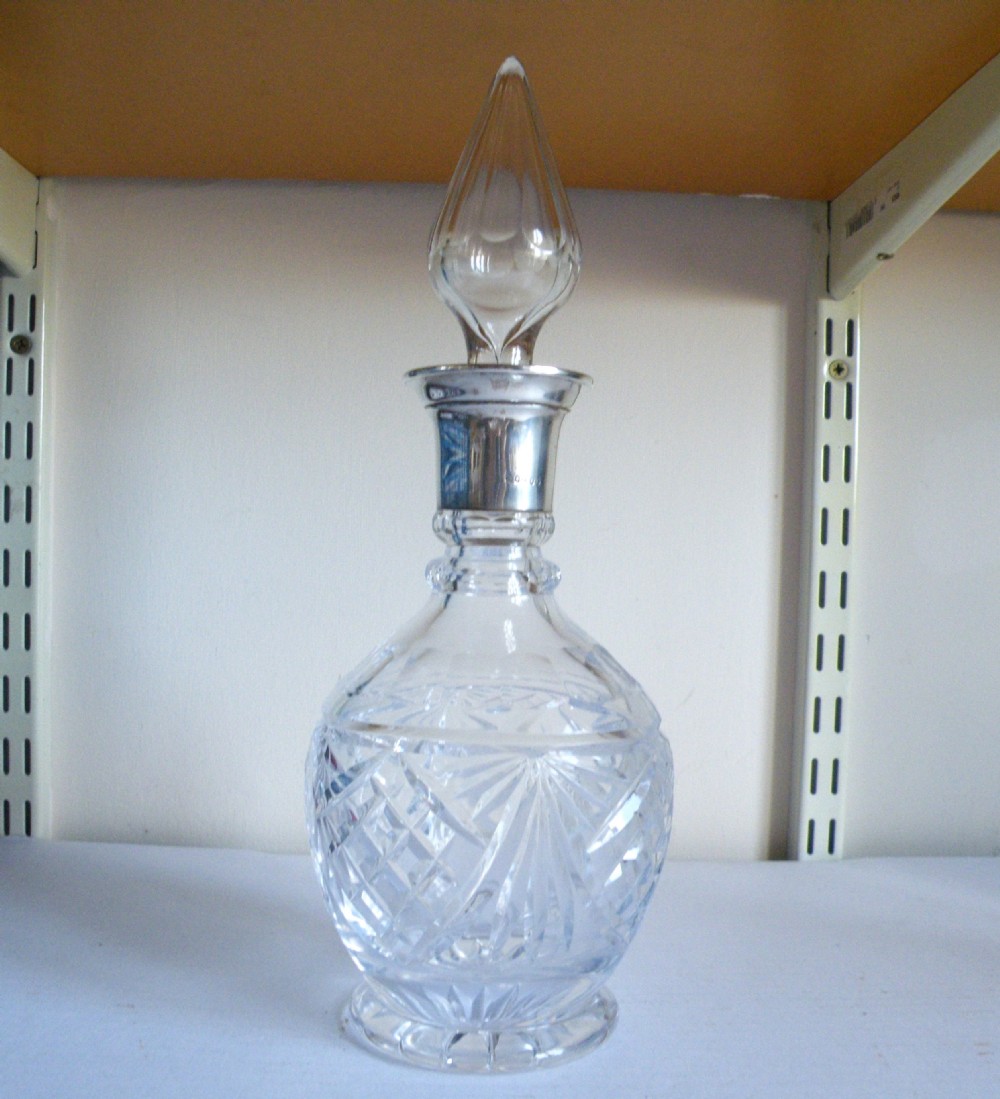 a cut glass silver mounted decanter