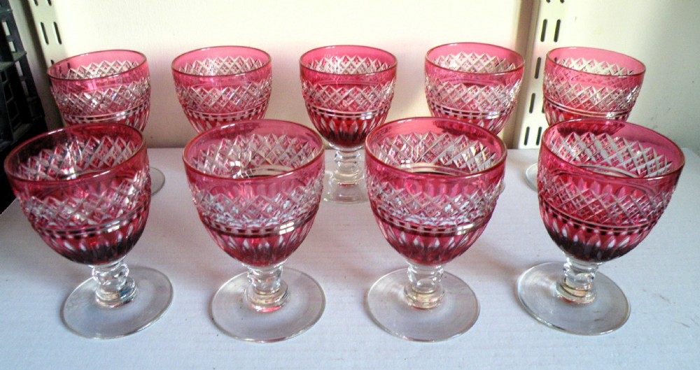a fine set of 9 victorian cranberry cut to clear wine glasses