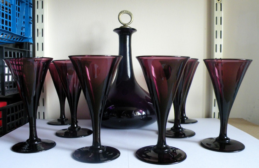 a good georgian amethyst glass suite of decanter and eight wine glasses