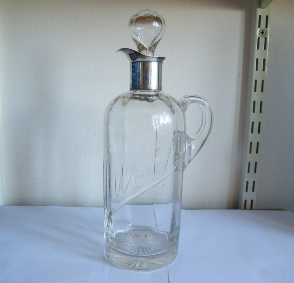 a 1905 edwardian silver and glass whisky jug