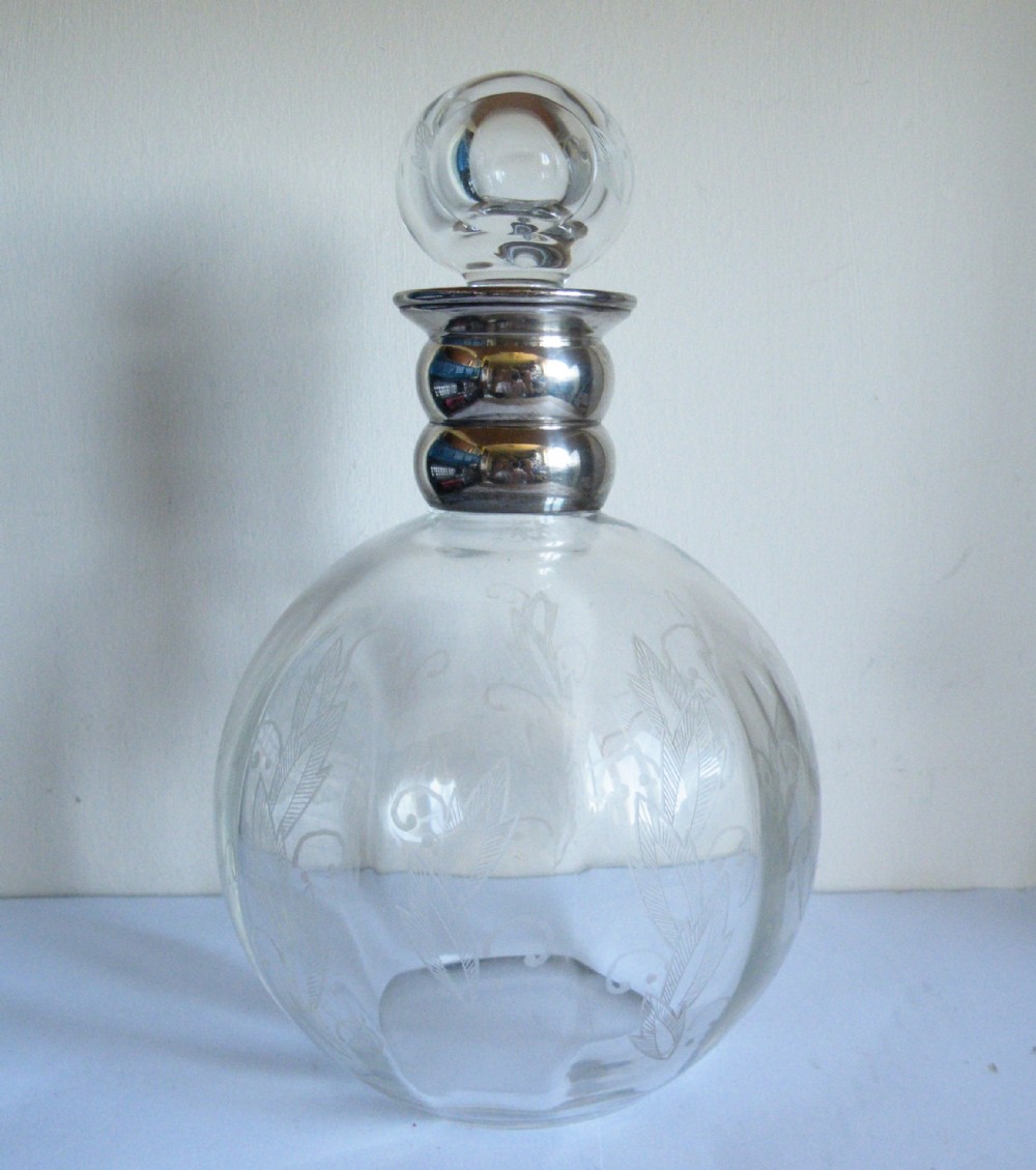 an edwardian engraved glass and silver decanter