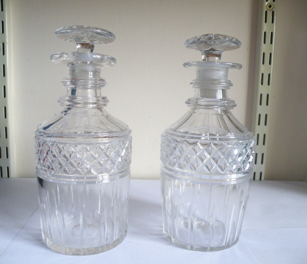 a pair of georgian glass half bottle or spirit decanters