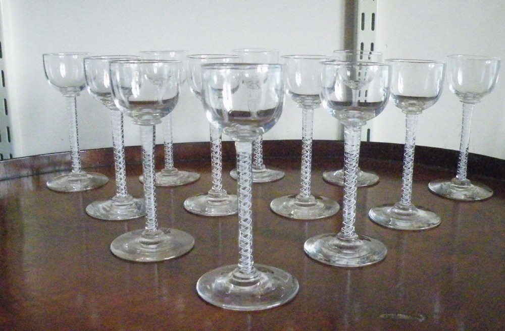 a very rare set of 12 mid 19th century scottish liquer glasses with opaque twist stems