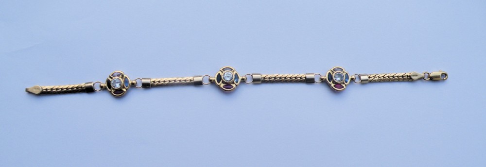 a pretty 18ct gold gem set bracelet