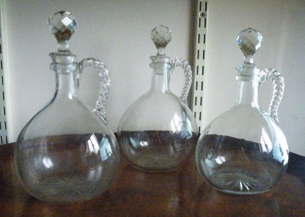 a good set of three 19th century glass claret jugs