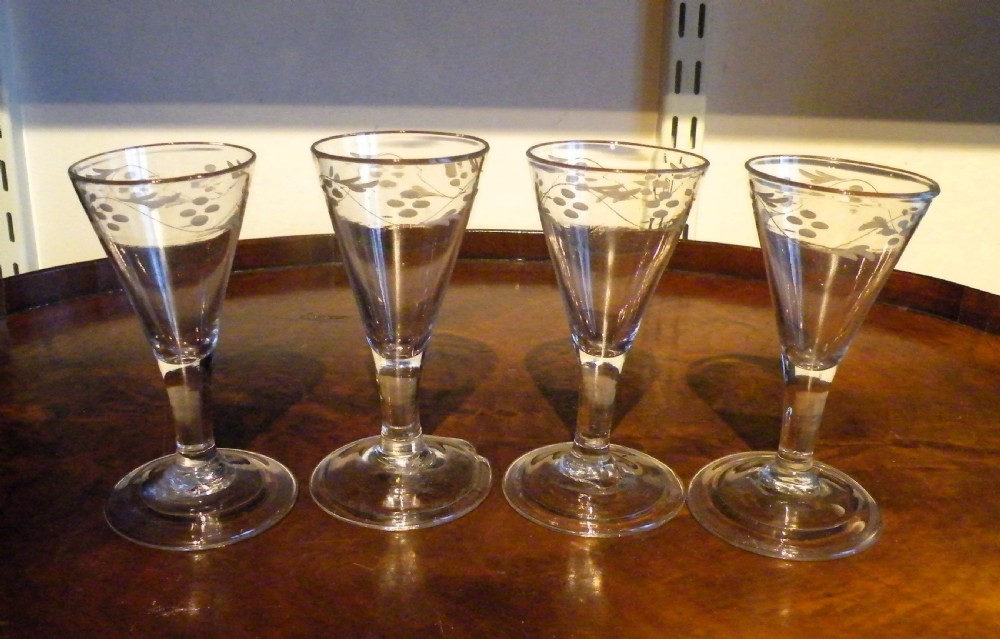 a set of four 18th century engraved wine glasses