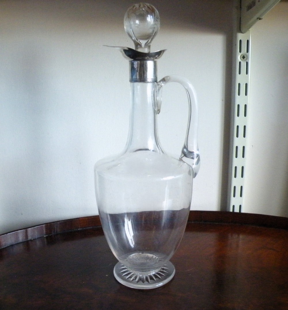 an early 20th century silver and glass claret jug