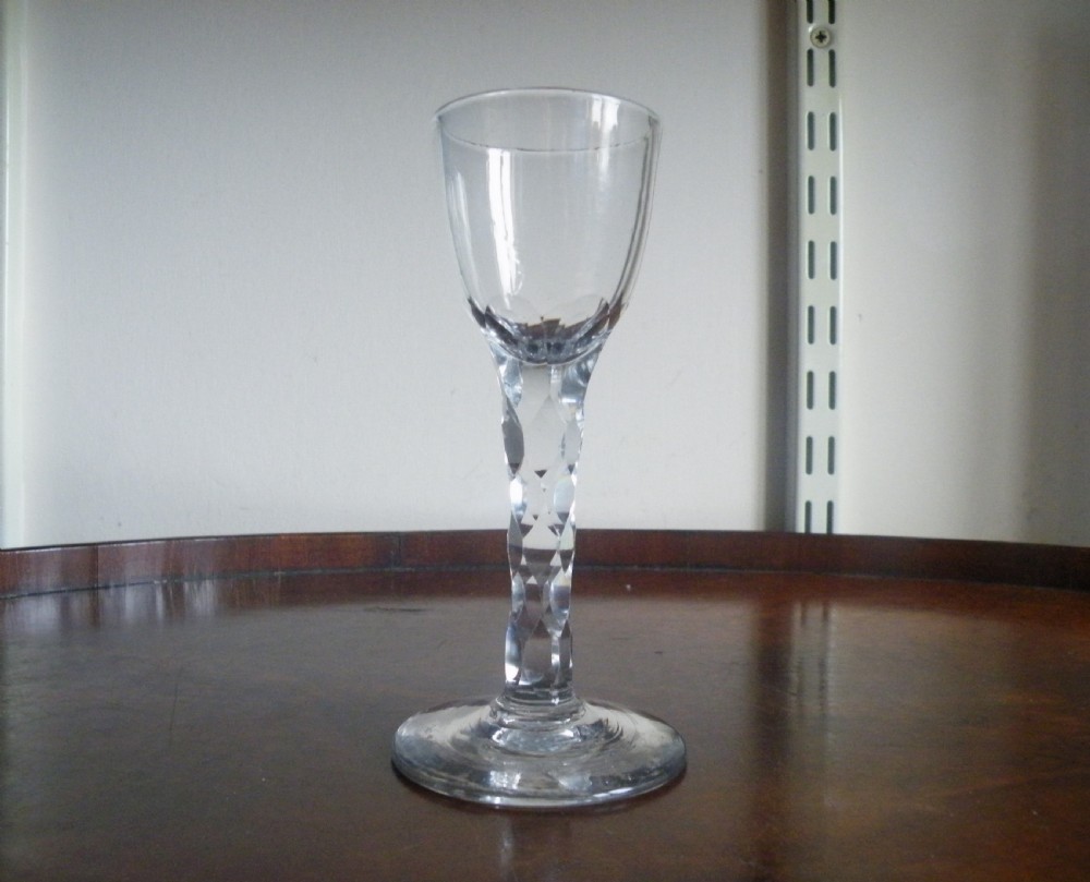 an 18th century facet cut stem wine glass