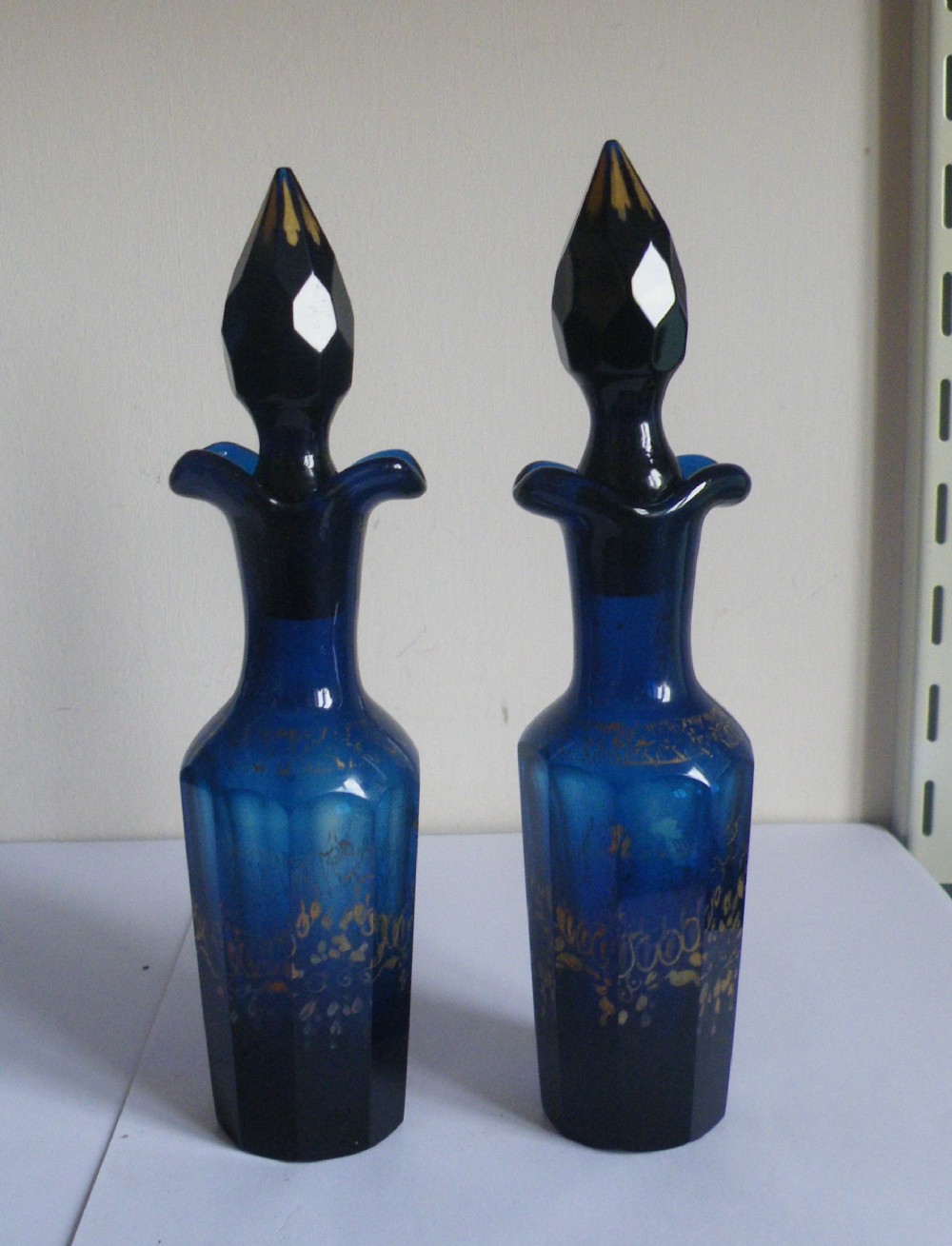 a good pair of georgian bristol blue glass sauce bottles with gilding