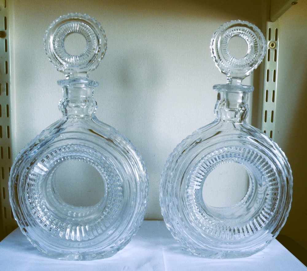 a very rare pair of tyre shape glass decanters