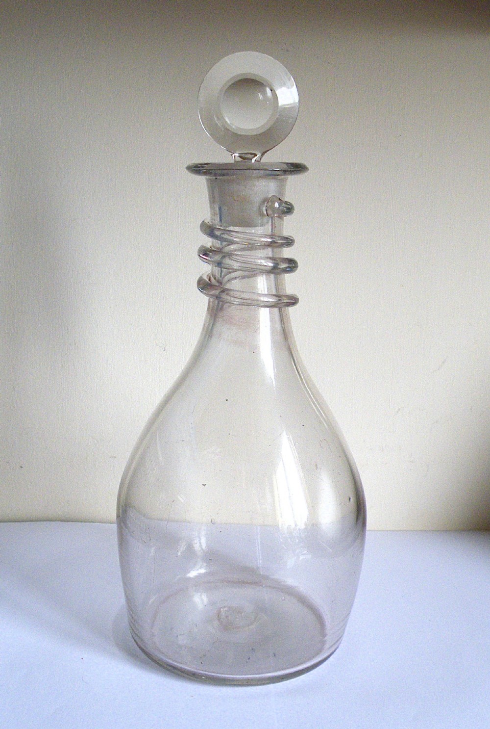 an unusual 18th century plain decanter with a snake ring neck